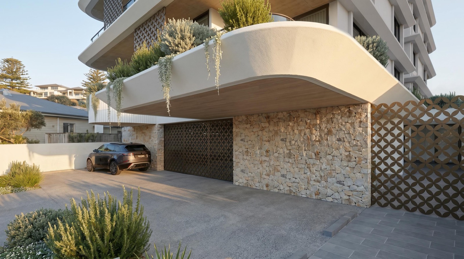 Lucia's stone-clad entry and curved planter over the driveway